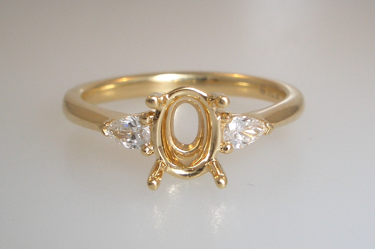Pear Accented Engagement Ring